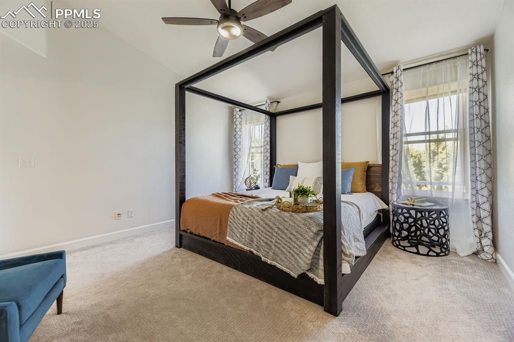 Image 20 of 32: Bedroom with carpet floors and ceiling fan