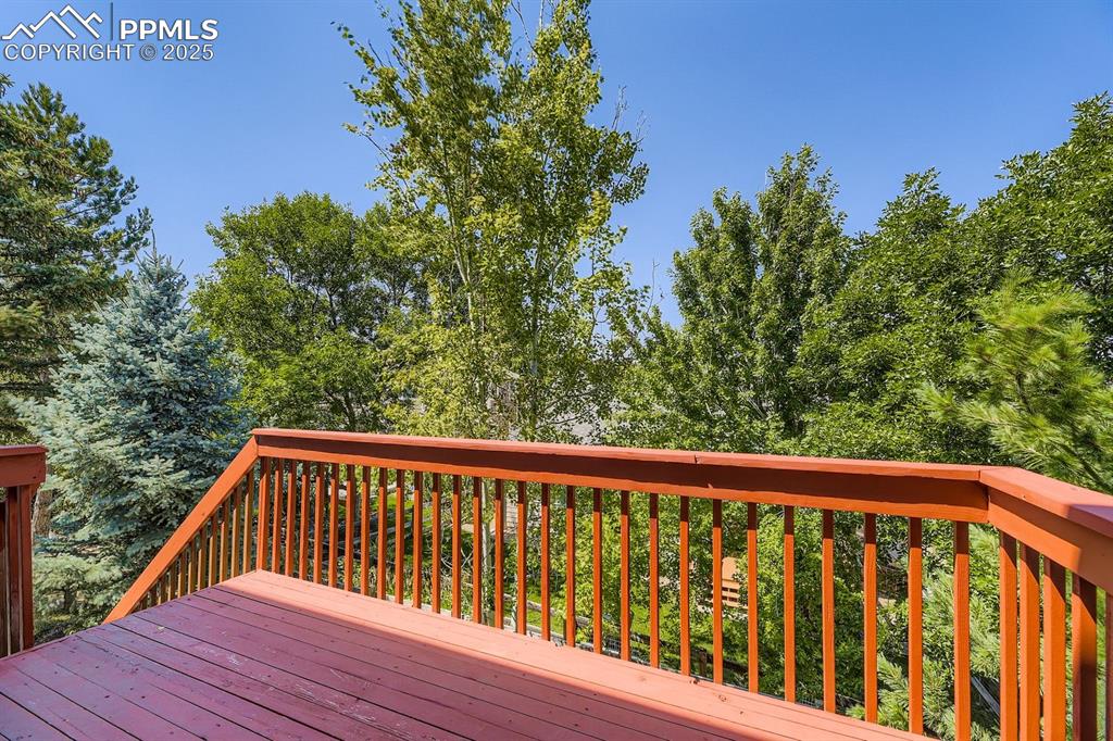 Image 25 of 32: Wooden terrace with view of scattered trees