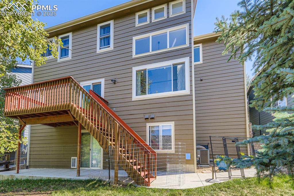 Image 26 of 32: Back of property featuring stairs, a patio area, and a deck