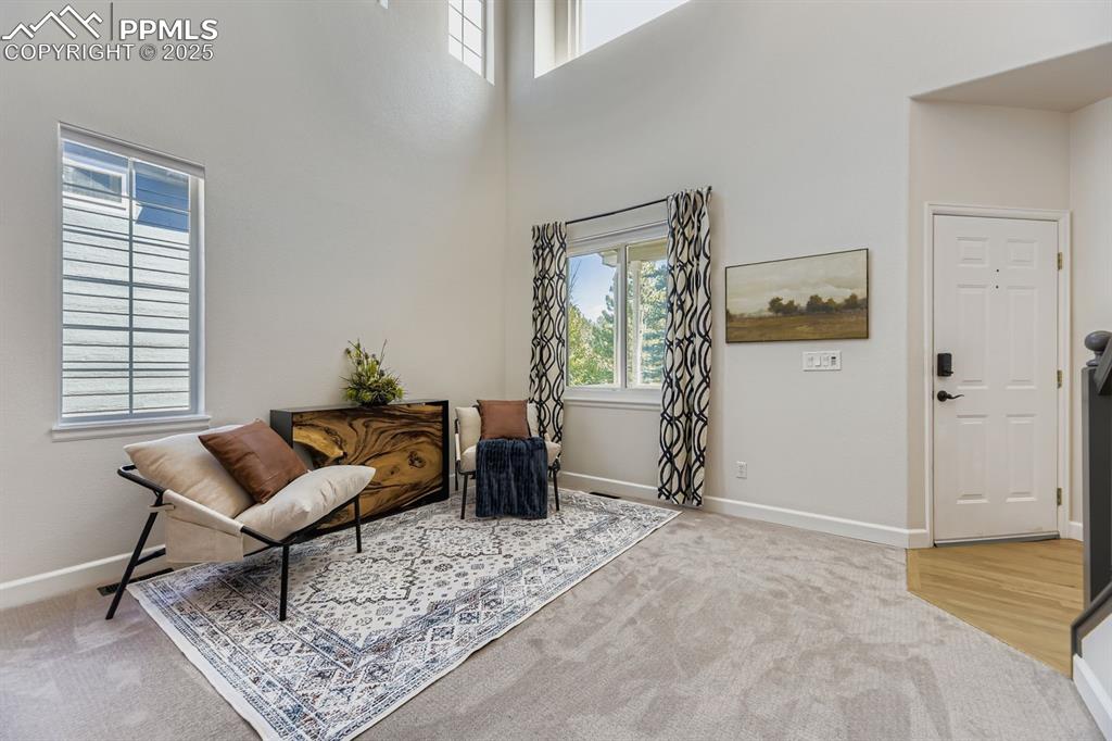 Image 6 of 32: Sitting room featuring healthy amount of natural light, light colored carpe