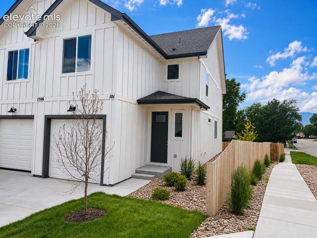 Image 1 of 19: Modern farmhouse exterior featuring vertical white siding, black trim accen