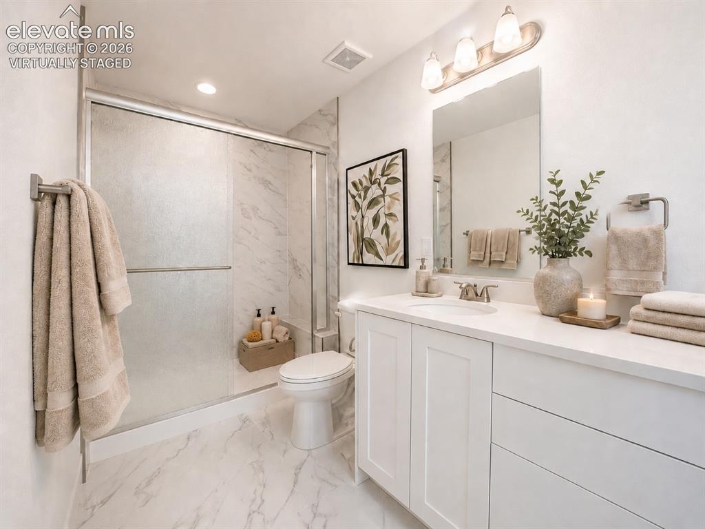 Image 10 of 19: Virtually Staged Bathroom featuring a white vanity with shaker-style cabine