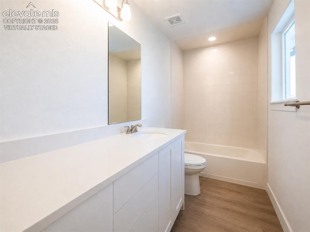Image 17 of 19: Virtually Staged Bathroom featuring a white vanity with a quartz countertop