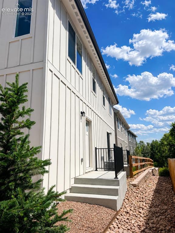 Image 2 of 19: Modern exterior with vertical board and batten siding
