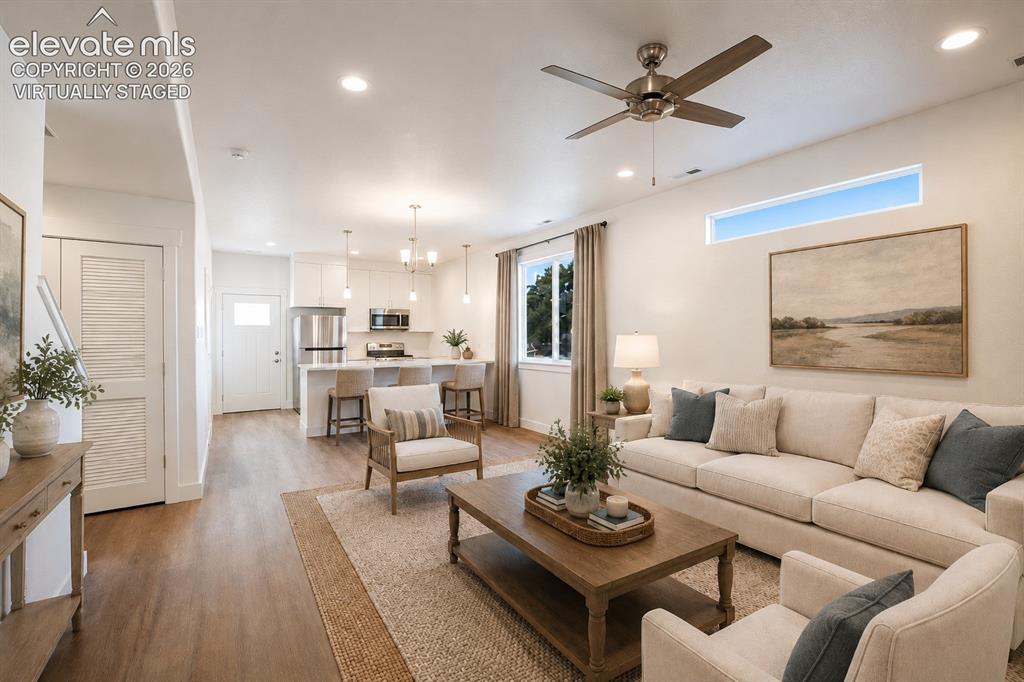 Image 4 of 19: Virtually Staged Open-concept living area featuring wood-finish flooring, r