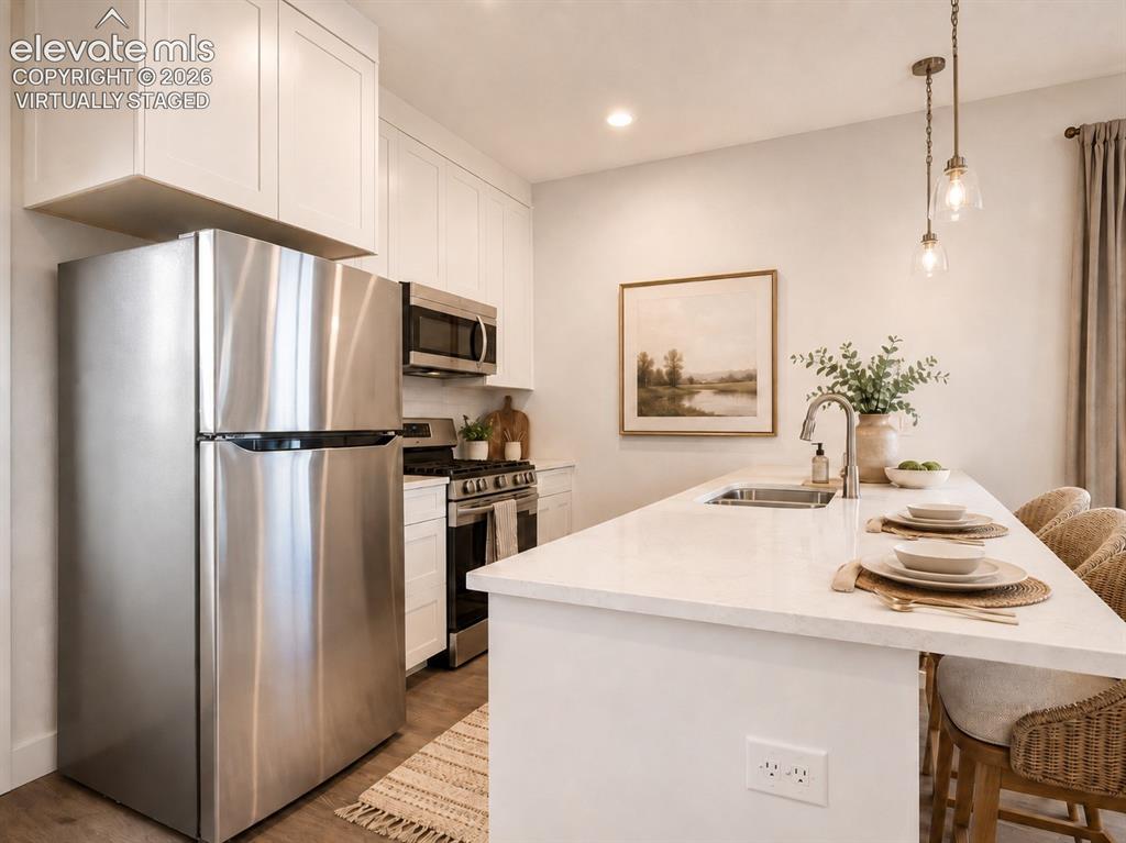 Image 6 of 19: Virtually Staged Kitchen island with integrated sink and brushed nickel fau