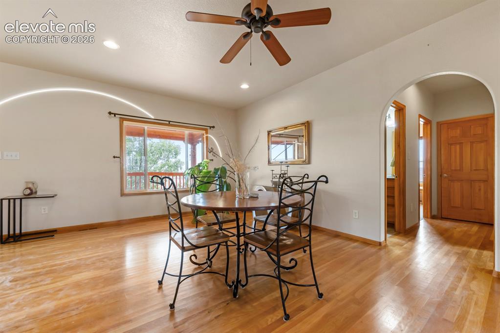 Image 11 of 50: Home is light and bright on the main level. Through the arch are 2 bedroom