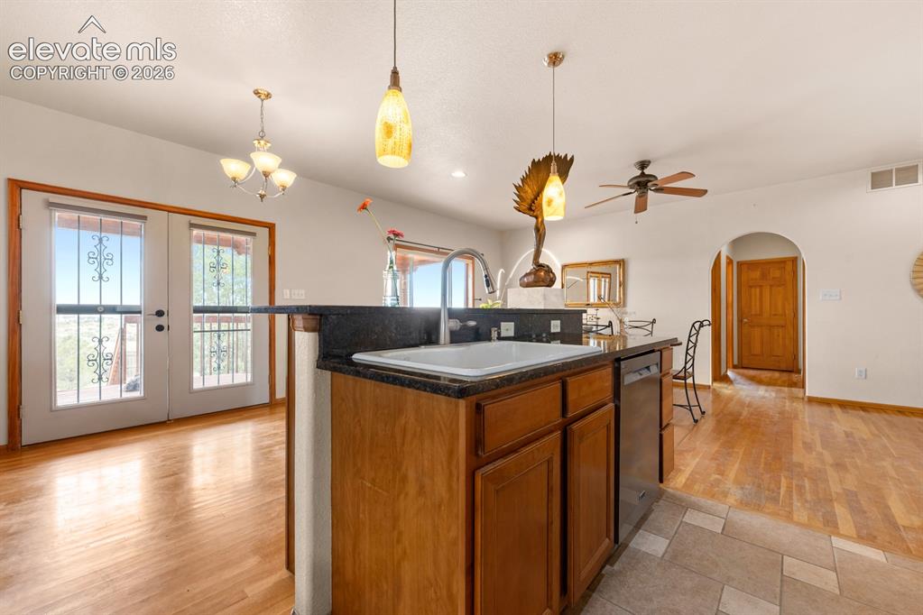 Image 15 of 50: Tile and hardwoods on the main level.  Beautiful french doors extend to the