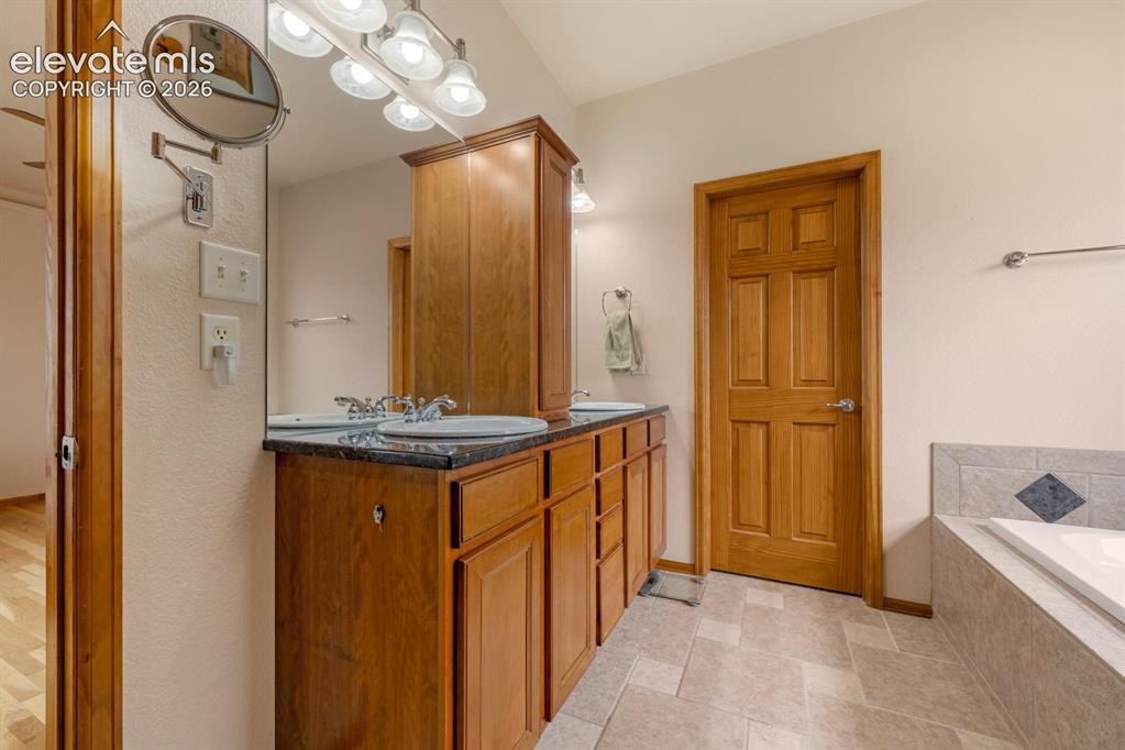 Image 21 of 50: A true 5 piece bathroom. Spa like bath offers a luxurious soaking tub, stu