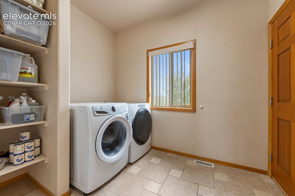 Image 31 of 50: Laundry is on the main level off hall or from the garage. Washer and dryer