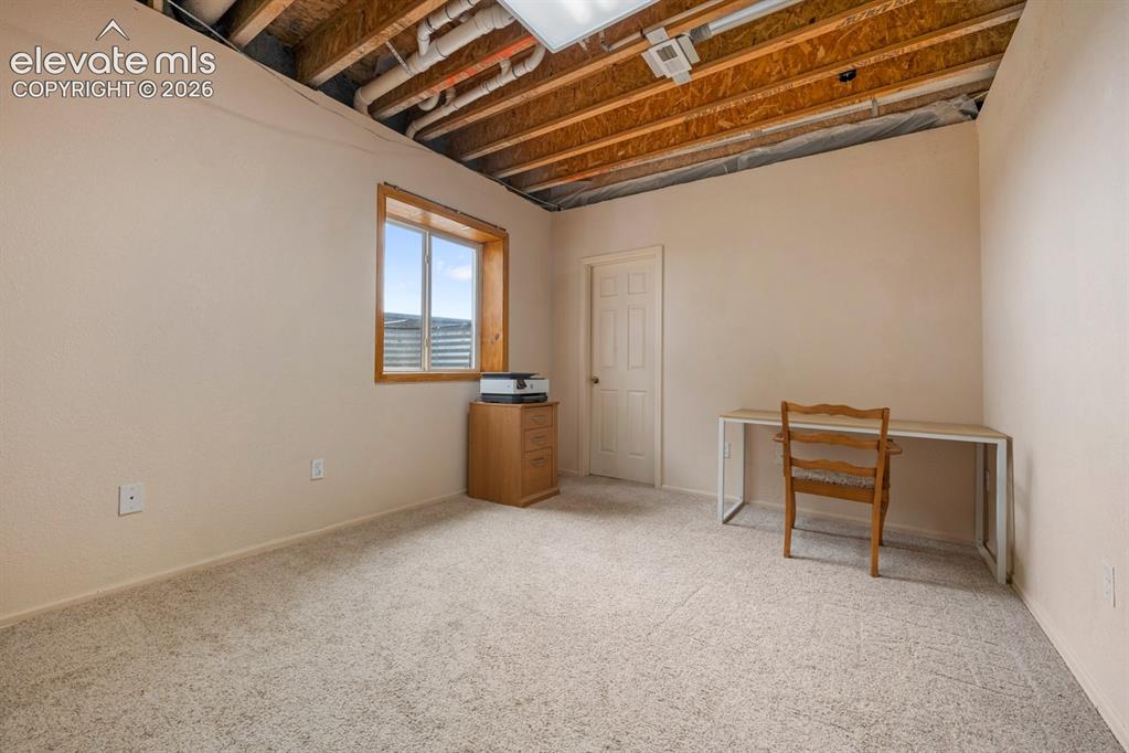Image 36 of 50: Bedroom at the back of the home garden level with walk in closet.