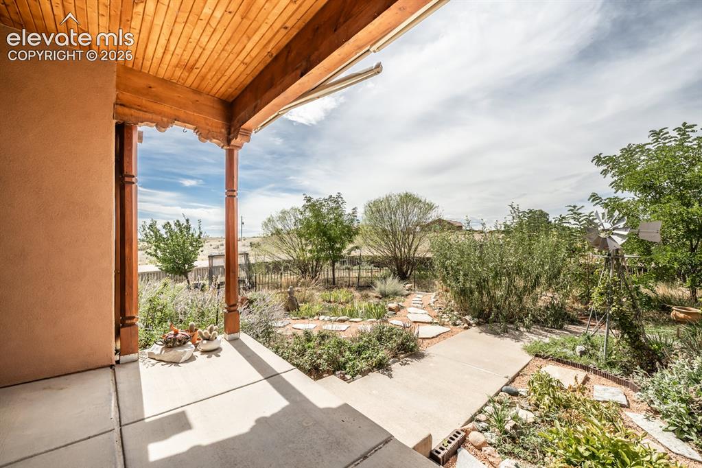 Image 7 of 50: Front door faces west overlooking this gem of a yard.  Perfect to sit out o