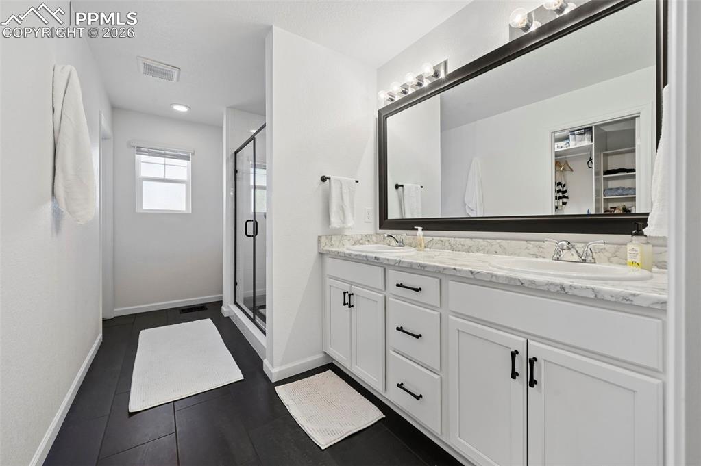 Image 27 of 37: Primary Bathroom with Double Vanity & Toilet Closet