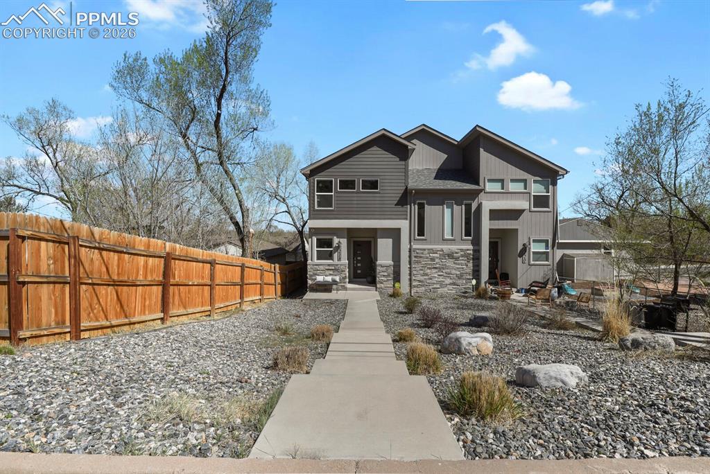 Caption: Contemporary facade with stone accents and horizontal siding