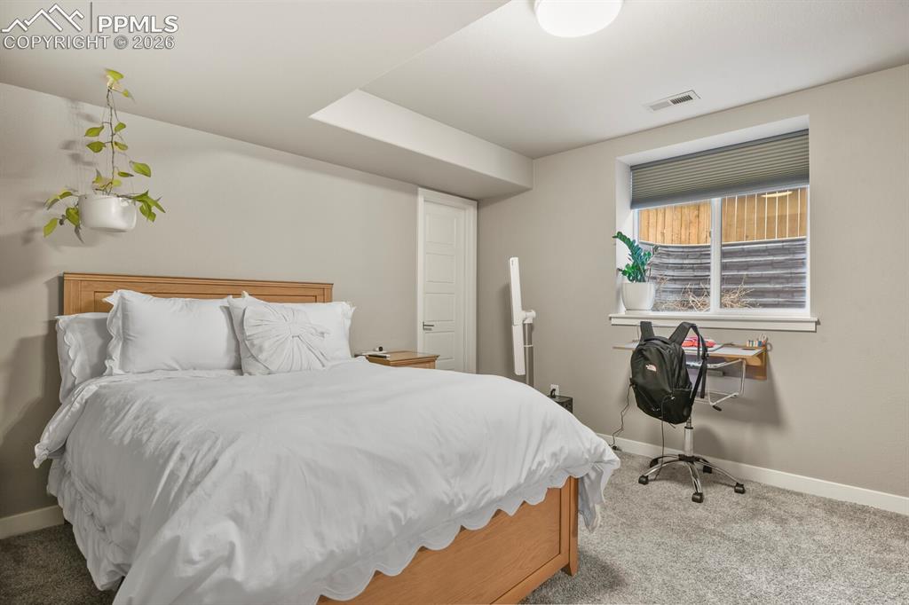 Image 17 of 33: Light-toned wall paint and grey carpeting create a neutral palette