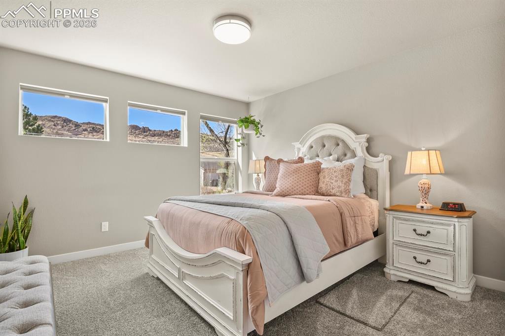 Image 24 of 33: Spacious room featuring neutral-toned walls, plush carpet flooring, and mul