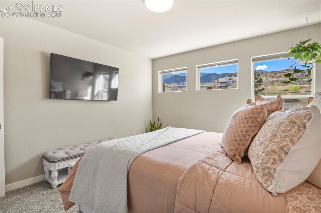 Image 25 of 33: Bedroom featuring three rectangular windows, recessed lighting, and light-c