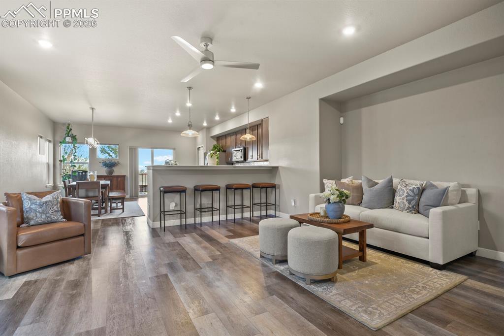 Image 6 of 33: Spacious living area featuring wood-finish flooring, recessed lighting, and