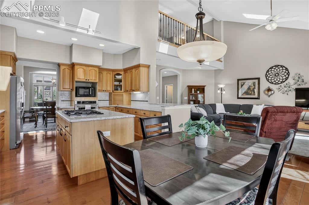 Image 3 of 46: Updated kitchen and cozy nook flow into the family room, with an open loft