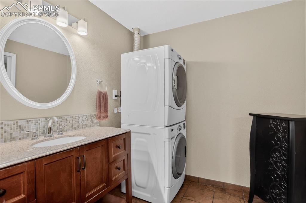 Image 38 of 46: This bath/laundry space is inside the ensuite downstairs and great for comp