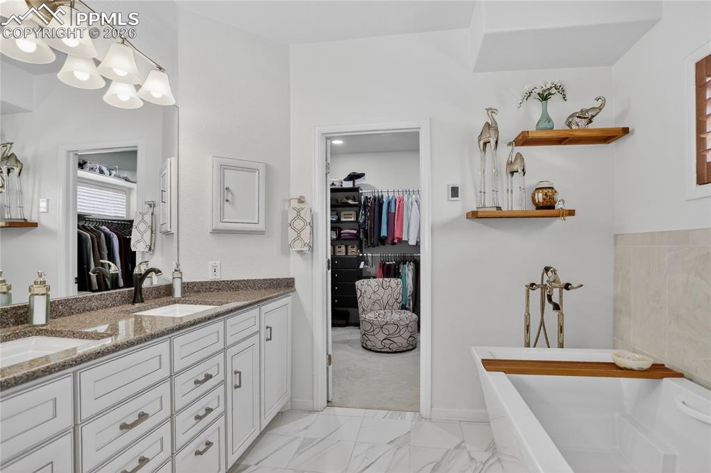 Image 5 of 46: This primary 5 piece bath has radiant floor, and a comprehensive r remodel