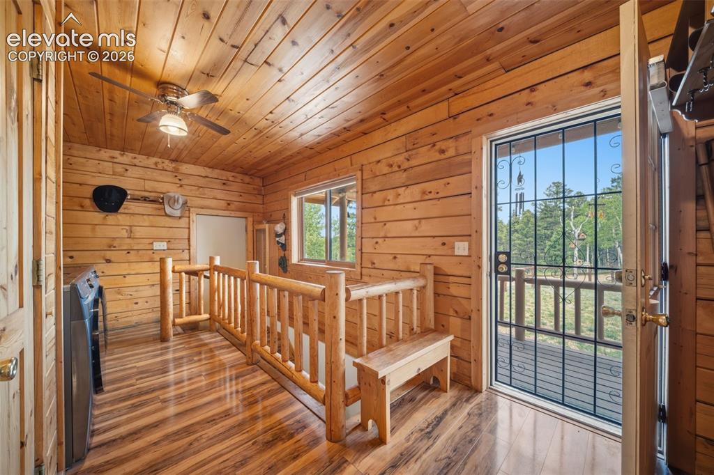 Image 10 of 39: Main level entry with rustic log railing