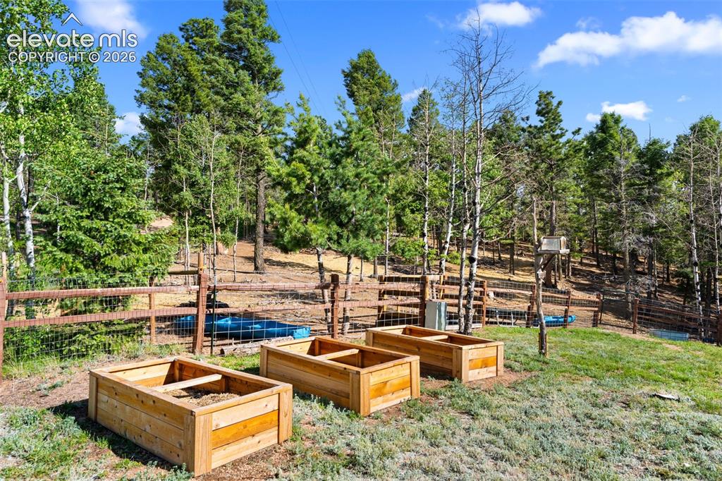 Image 26 of 39: Front yard with raised beds
