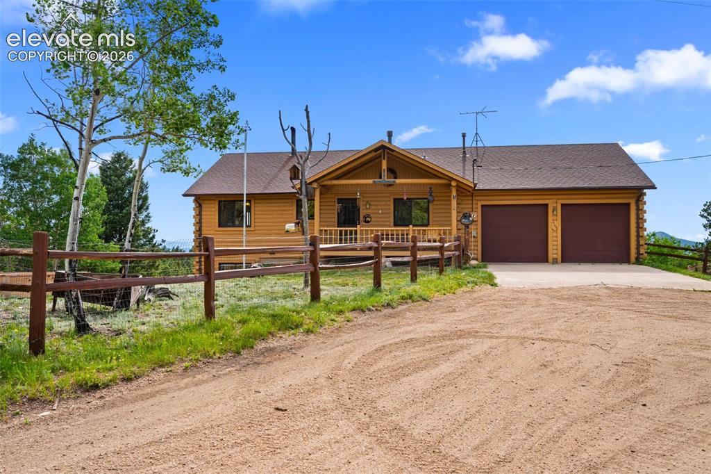 Image 3 of 39: Log home with 2 car attached garage