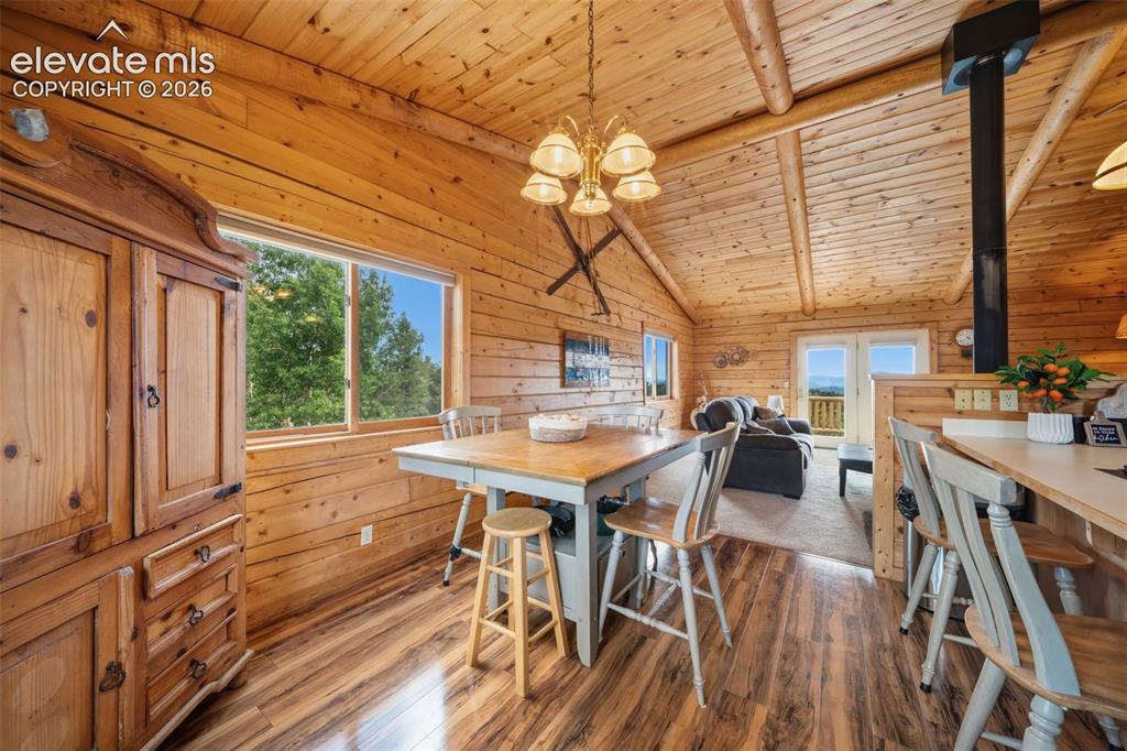 Image 7 of 39: Main level dining room open to kitchen and living room