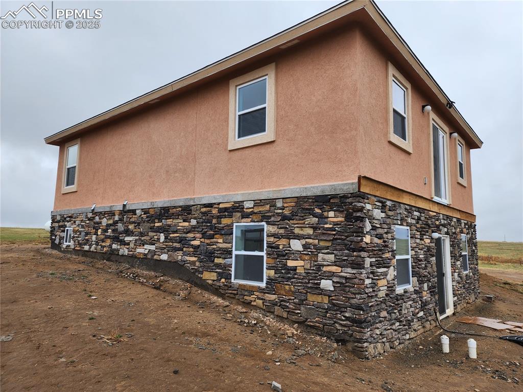 Image 4 of 28: Exterior details featuring heating fuel and stucco siding