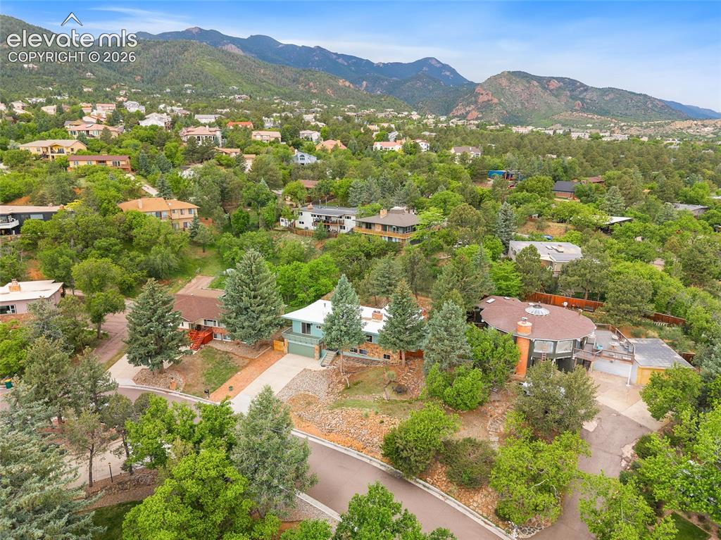 Image 44 of 50: Residential architecture nestled within a verdant, mountainous landscape