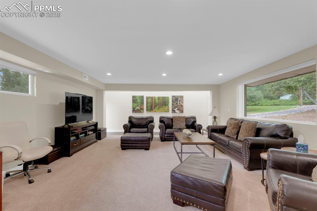 Image 21 of 43: Family room with recessed lighting and ample natural light