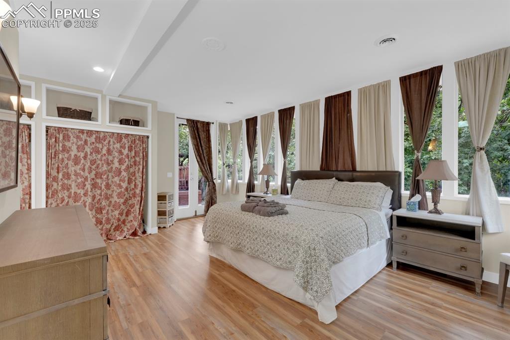 Image 23 of 43: Light wood-style flooring with walkout to deck