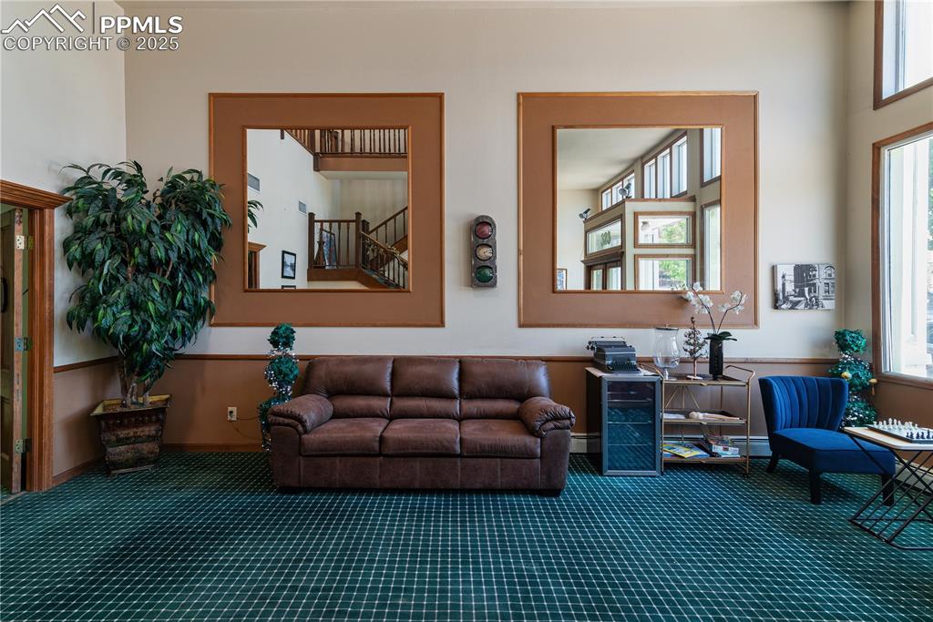 Image 15 of 31: Living area with plenty of natural light and carpet floors