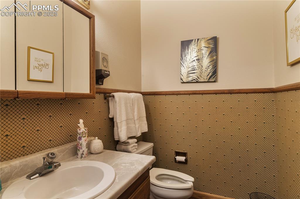 Image 21 of 31: Half bathroom with toilet and vanity
