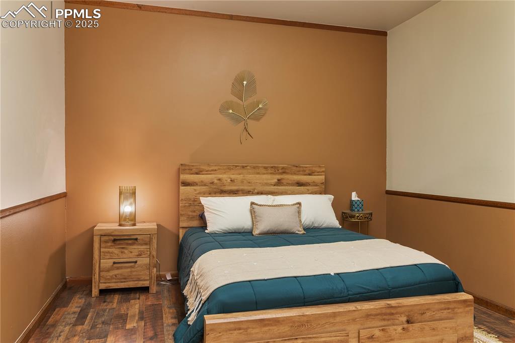 Image 23 of 31: Bedroom with baseboards and wood finished floors