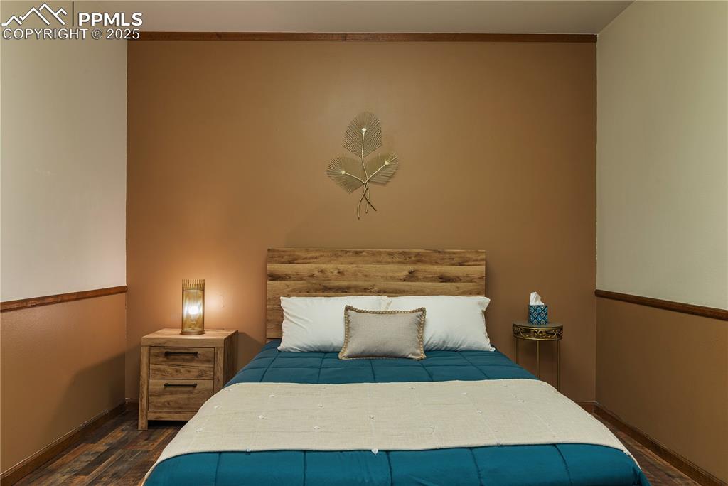Image 26 of 31: Bedroom featuring baseboards and wood finished floors