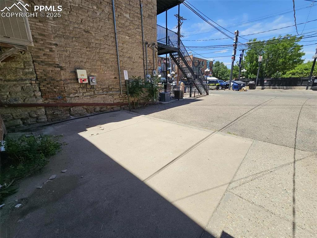 Image 31 of 31: View of asphalt road featuring stairway