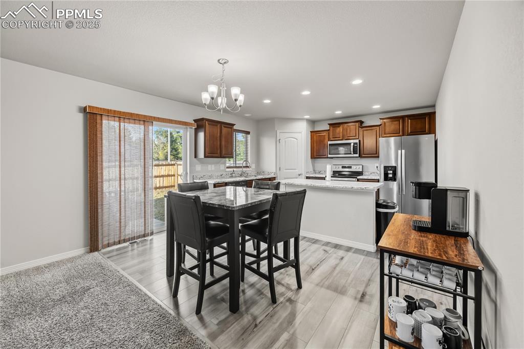 Image 10 of 33: Dining space featuring recessed lighting, a chandelier, light wood-style fl