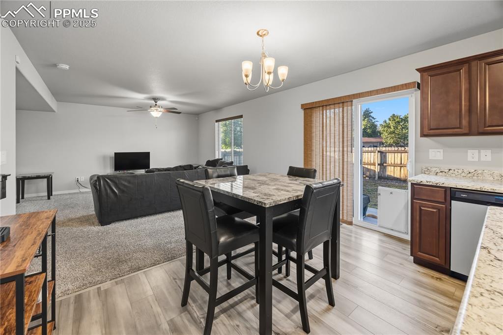Image 15 of 33: Dining room featuring a chandelier, light wood-type flooring, and ceiling f