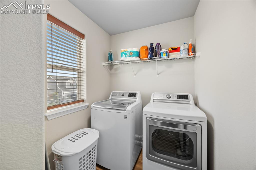 Image 21 of 33: Washroom with healthy amount of natural light, separate washer and dryer, a