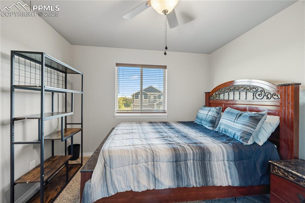 Image 23 of 33: Carpeted bedroom featuring ceiling fan and baseboards