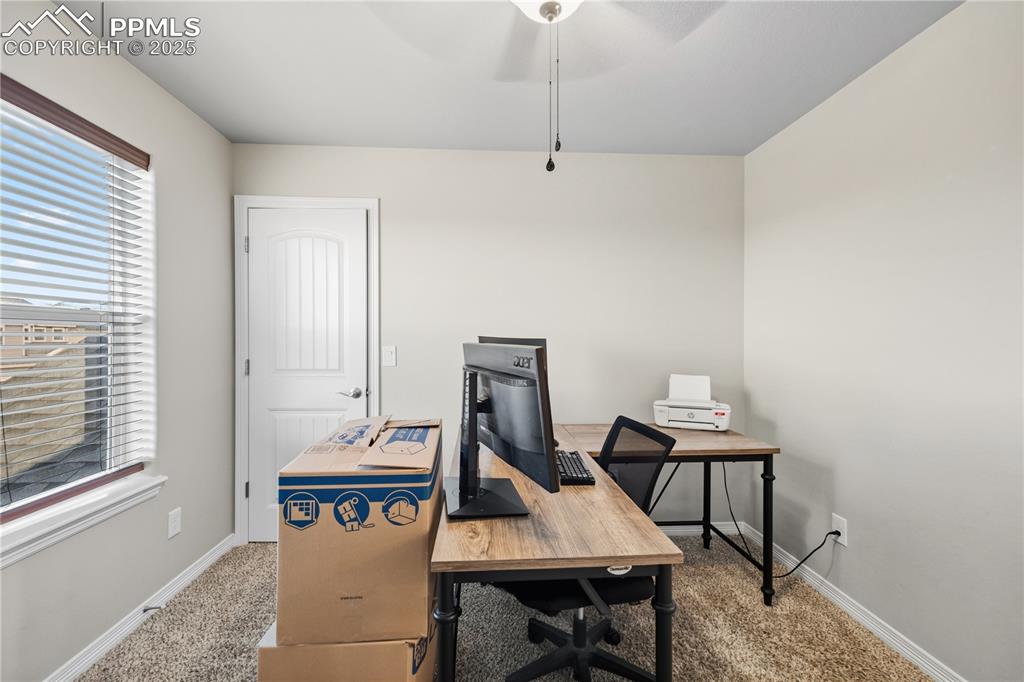 Image 26 of 33: Carpeted office featuring a ceiling fan and baseboards