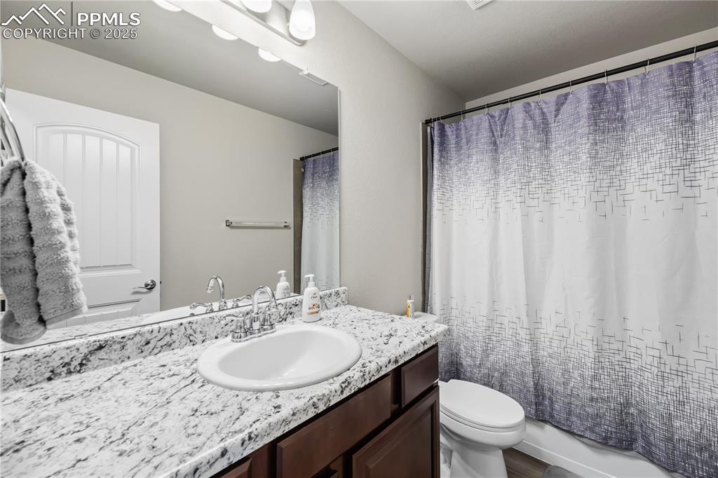 Image 27 of 33: Full bathroom featuring vanity and shower / tub combo