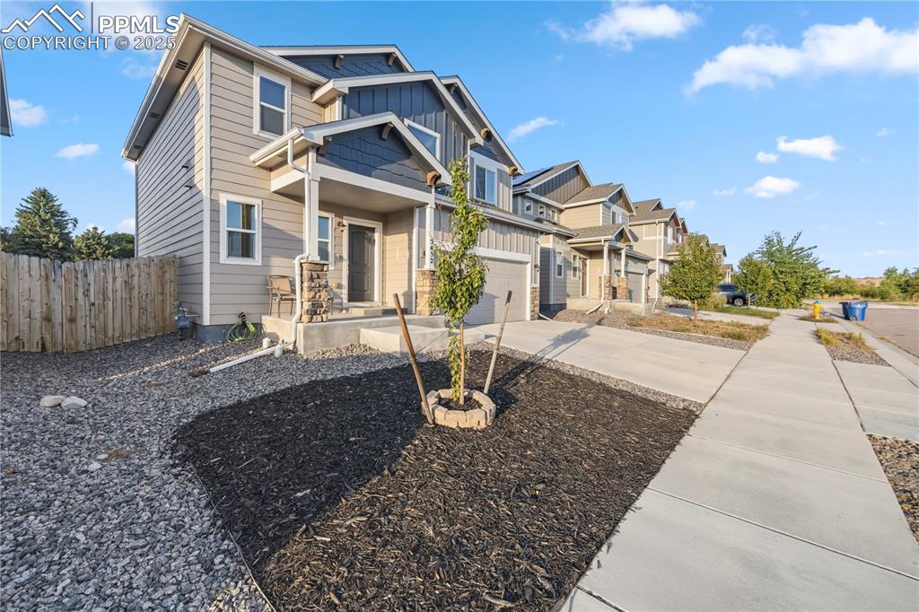 Image 3 of 33: View of front of property featuring board and batten siding, concrete drive
