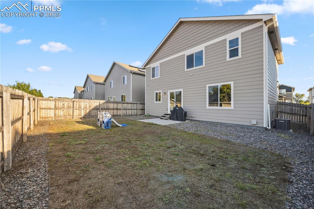 Image 32 of 33: Rear view of house featuring a patio and a fenced backyard