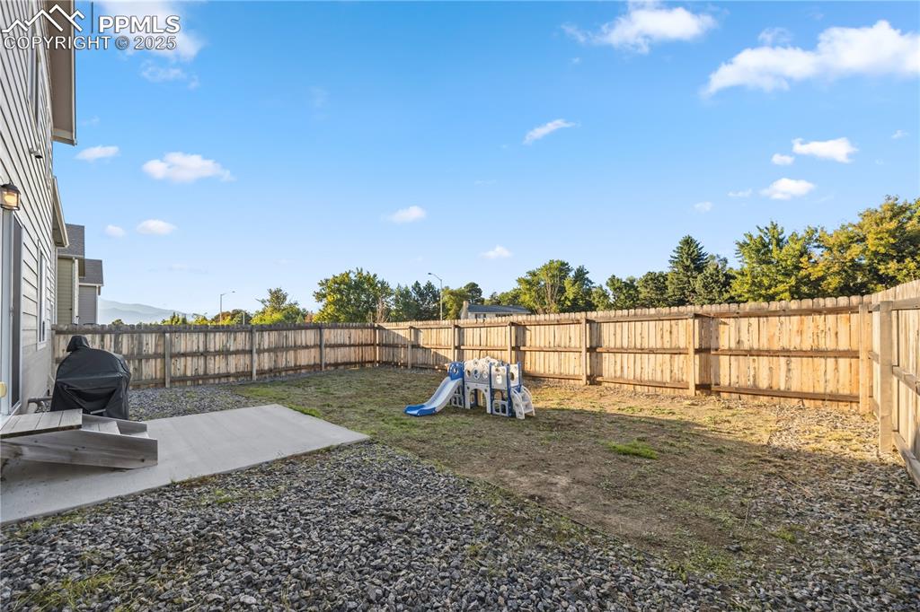 Image 33 of 33: Fenced backyard featuring a patio