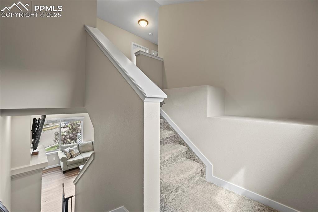 Image 18 of 44: Stairs with baseboards and wood finished floors