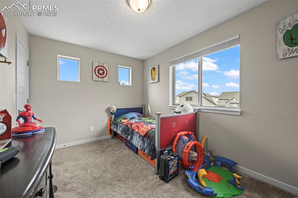 Image 20 of 44: Bedroom featuring baseboards and carpet flooring