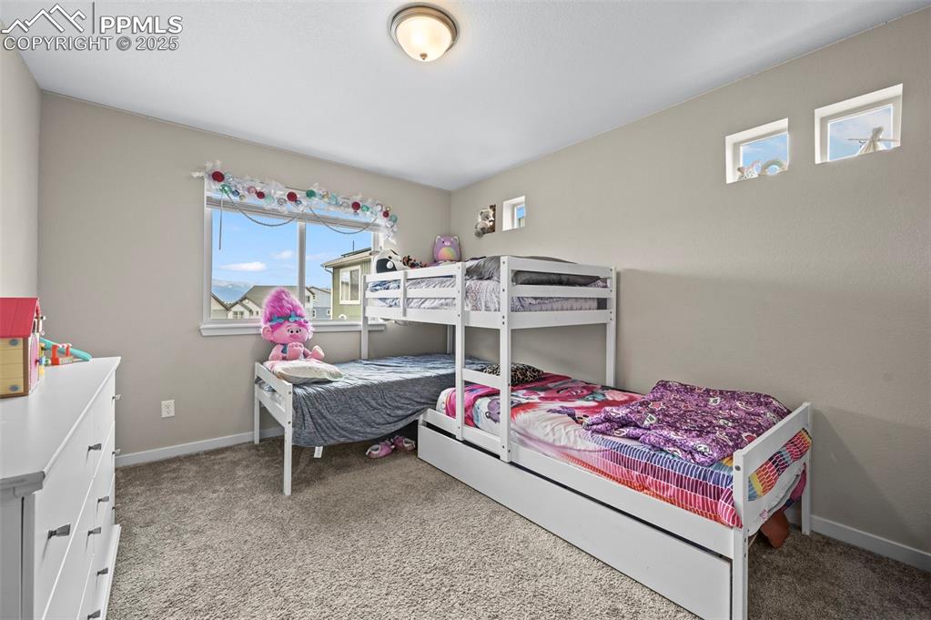 Image 23 of 44: Carpeted bedroom with baseboards